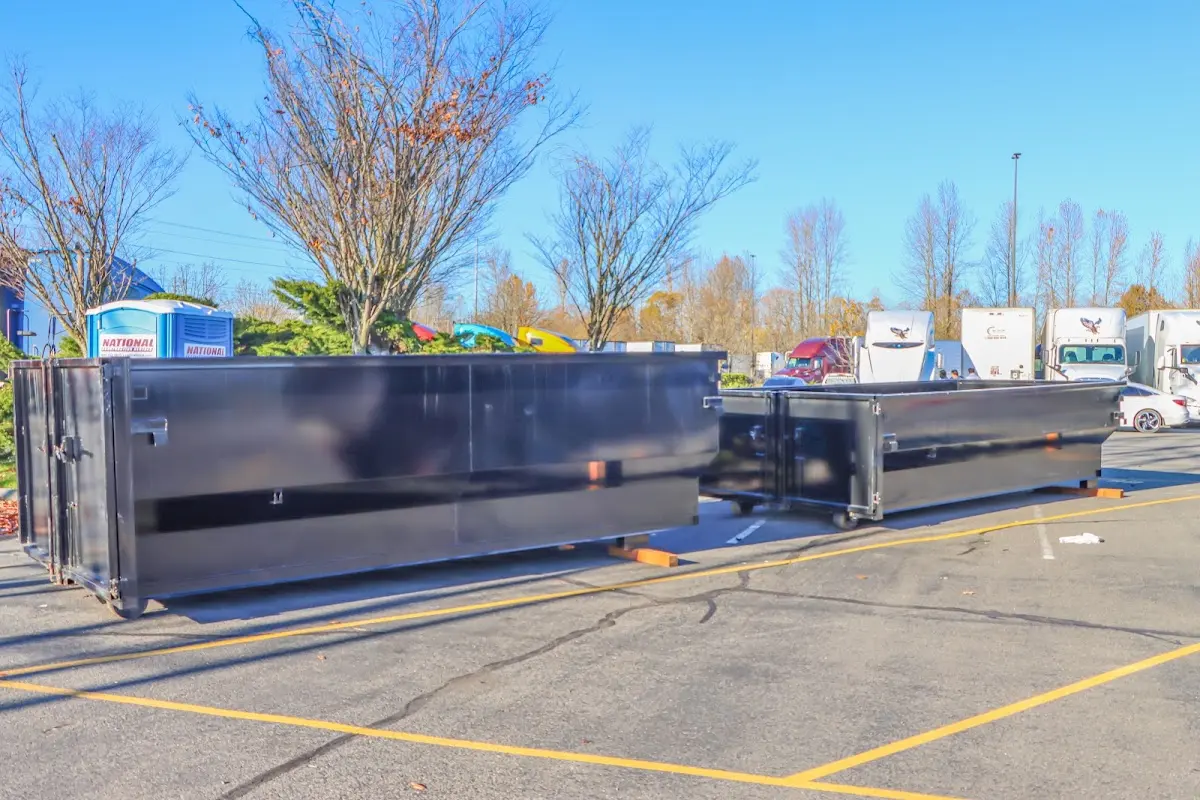 Professional dumpster rental service with roll-off container on residential driveway in Los Ranchos de Albuquerque